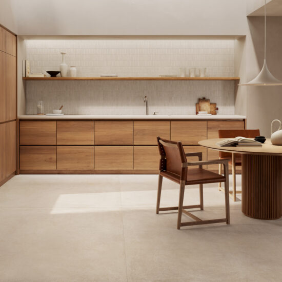 Modern kitchen with wooden furniture, round table and chairs, warm lighting and minimalist decorations.