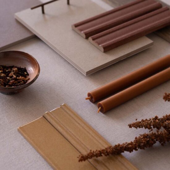Surface with various samples of porcelain stoneware in warm tones, natural style details, and glossy finishes.
