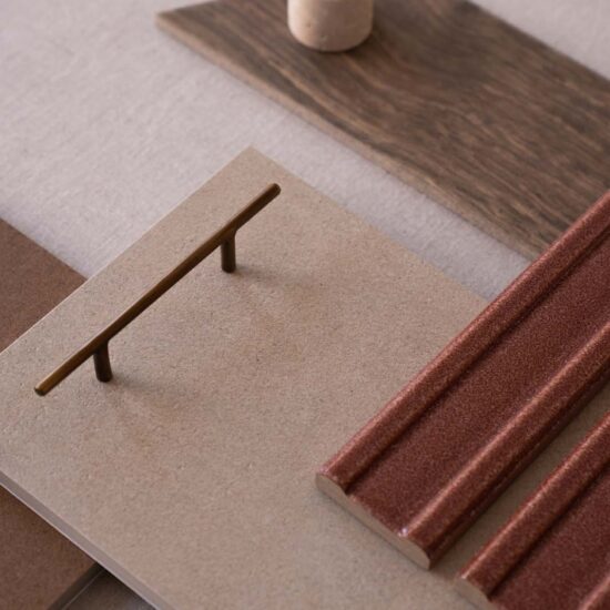 Surface with various tiles in shades of brown and a glossy decoration, paired with minimalist design elements.